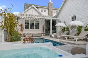 Back of house with a patio, a pergola, and an outdoor living space