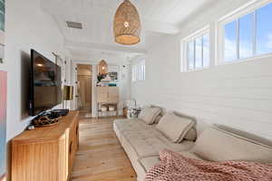 Living room featuring light hardwood / wood-style floors, wood ceiling, and plenty of natural light