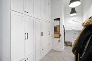 Mudroom featuring light tile patterned flooring