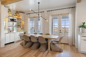 Dining area with french doors, wooden ceiling, and light hardwood / wood-style flooring