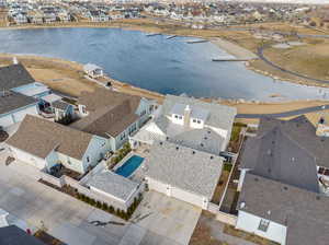 Birds eye view of property with a water view