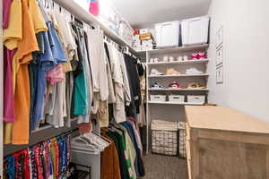 Walk in closet featuring carpet flooring