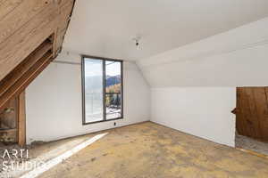 upstairs living space with vaulted ceiling