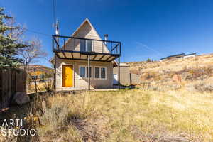 Rear view of property featuring a balcony