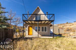 Back of property with a balcony