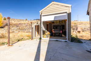 View of outbuilding with a garageATV excluded.