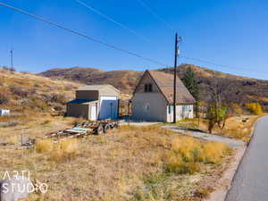 Exterior space with a mountain view, a garage, and an outdoor structure