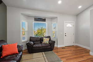 Entrance foyer with hardwood / wood-style floors