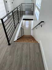 Stairway featuring hardwood / wood-style flooring