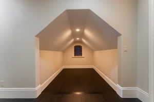 Bonus room featuring hardwood / wood-style flooring and vaulted ceiling