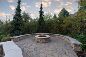 Patio terrace at dusk featuring a fire pit