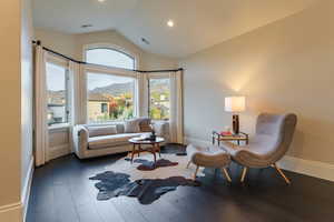 Sitting room featuring a mountain view, vaulted ceiling, and dark hardwood / wood-style flooring