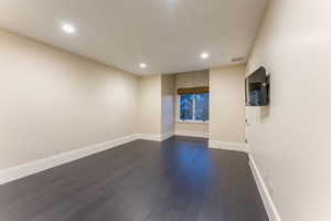 Unfurnished room featuring dark hardwood / wood-style flooring