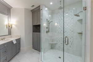 Bathroom with vanity and a shower with door