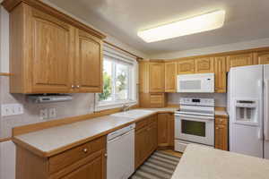 Kitchen featuring sink and white appliances