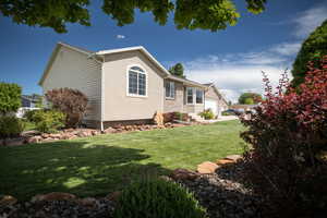 View of property exterior featuring a lawn