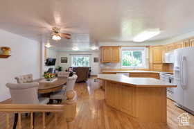 Kitchen with white appliances, a healthy amount of sunlight, and light wood-type flooring