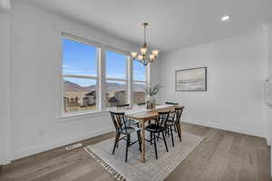 Dining area featuring a mountain view, a notable chandelier, and light hardwood / wood-style floors