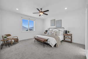 Carpeted bedroom featuring ceiling fan