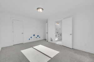 Unfurnished bedroom with light colored carpet