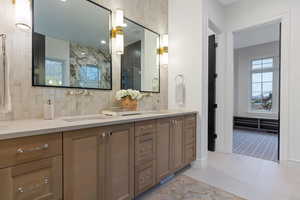 Bathroom featuring tile patterned flooring and vanity