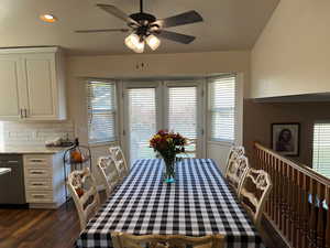 Dining space with dark hardwood / wood-style flooring, ceiling fan, and a wealth of natural light