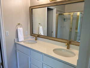 Bathroom featuring vanity and an enclosed shower