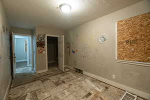 Empty room featuring a textured ceiling