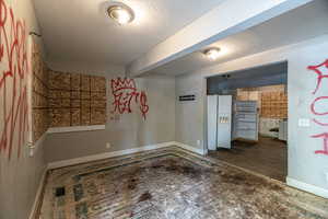 Unfurnished room featuring a textured ceiling