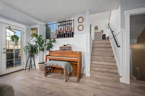 Misc room with hardwood / wood-style floors and a textured ceiling