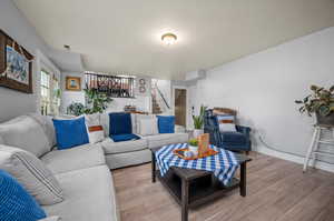 Living room with a textured ceiling and hardwood / wood-style flooring