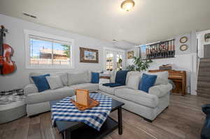 Living room featuring a textured ceiling and hardwood / wood-style floors