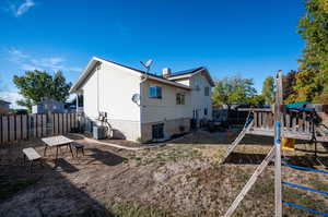 Back of property featuring a playground