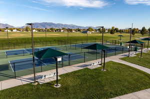 View of sport court featuring a yard and a mountain view