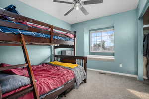 Bedroom with ceiling fan and carpet floors