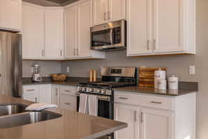 Kitchen featuring white cabinets and stainless steel appliances