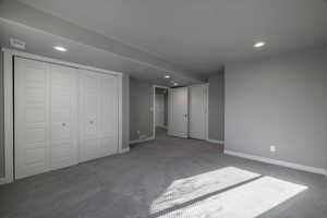 Unfurnished bedroom with a closet and carpet