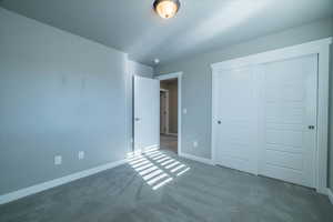 Unfurnished bedroom with a closet and carpet floors