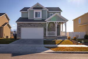 Craftsman-style home with a porch, a garage, and cooling unit