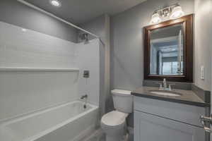 Full bathroom with vanity, toilet, and tiled shower / bath