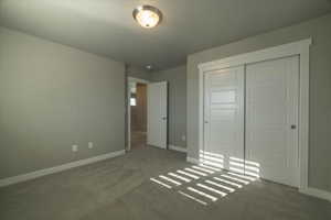 Unfurnished bedroom with a closet and carpet