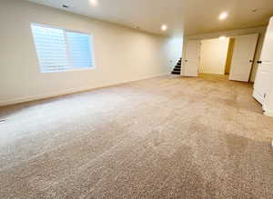 Basement with light colored carpet