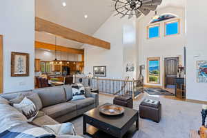 Living room featuring beam ceiling, high vaulted ceiling, and hardwood / wood-style flooring