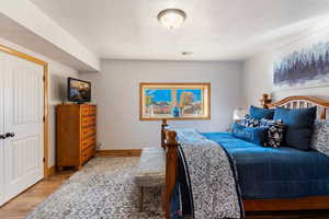 Bedroom #4 featuring a textured ceiling and light hardwood / wood-style flooring