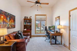 Bedroom #3 setup as an office with lofted ceiling and ceiling fan