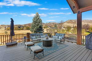 Wooden deck with a mountain view and outdoor lounge area