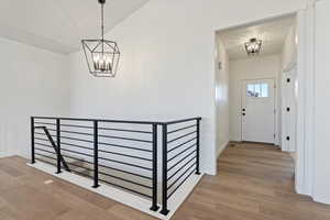 Entryway featuring a notable chandelier and hardwood / wood-style flooring