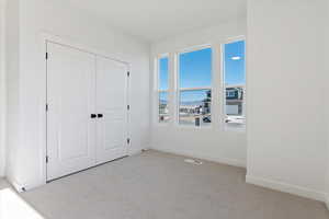 Bedroom featuring a closet and light colored carpet