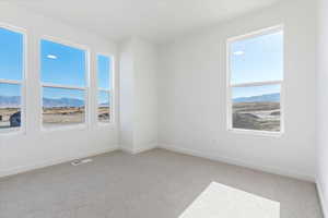Carpeted empty room featuring a mountain view