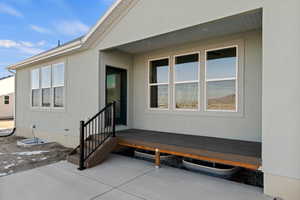 Doorway to property featuring a patio
